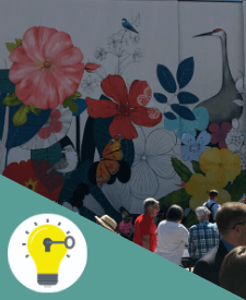 People in front of a flowered mural