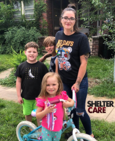 Picture of a young woman with her three children. 